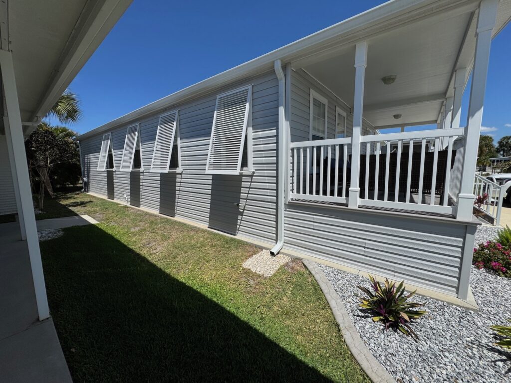 white Bahama shutters on mobile home Impact rated storm protection